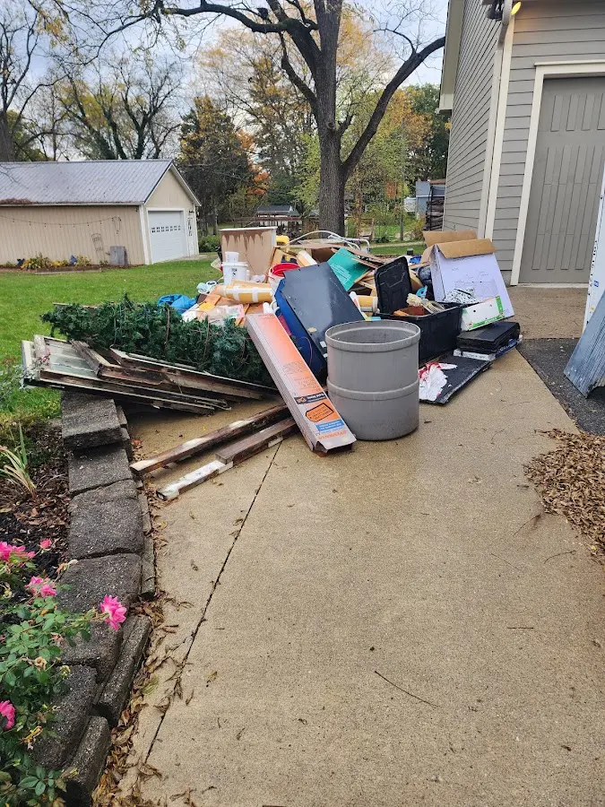 Dumpster being loaded with debris for Estate Cleanout Dumpster Rental in Island Park